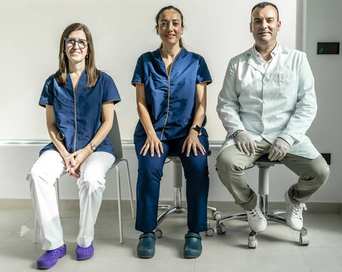 Male and female doctors sitting in dentist's clinic stock photo