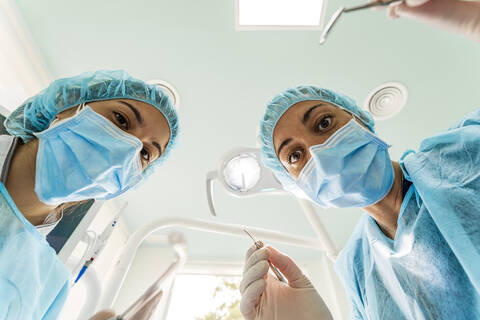 Doctor and nurse working in dentist's clinic stock photo