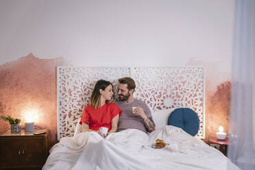 Romantic couple having breakfast on bed at home - EIF00148