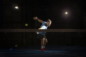 Mann spielt Padel in der Dunkelheit - ADSF07240