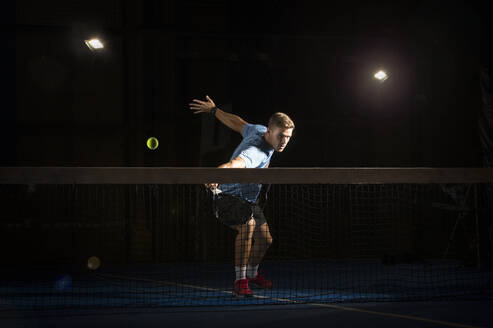 Man playing padel in darkness - ADSF07240