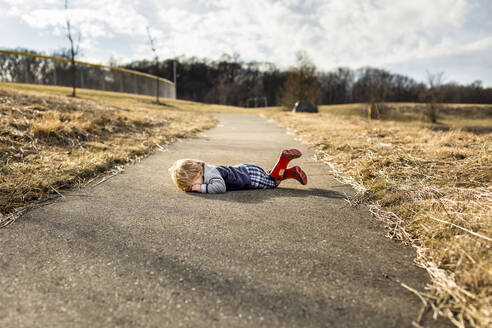 Toddler boy having a tantrum on walking path - CAVF87702