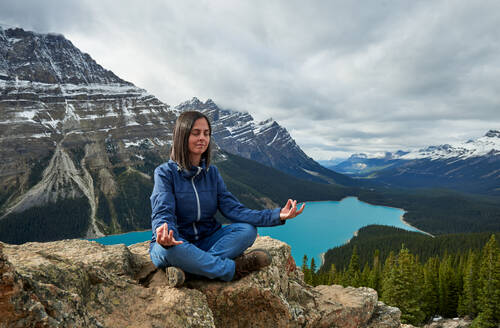 Entspannte Frau beim Yoga im Peyto Lake, Banff National Park - CAVF87795