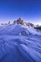 Starry sky at dusk on Ra Gusela mountain surrounded by fresh snow, Giau Pass, Dolomites, Belluno province, Veneto, Italy, Europe - RHPLF17050