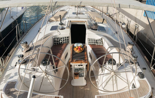 Von oben teuer Boot mit Früchten auf dem Tisch schwimmend auf dem Meer in sonnigen Tag - ADSF07309