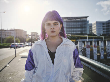 Fashion stylish woman with purple hairstyle in city center and confidently looking at camera in bright day - ADSF07451