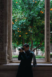 Traveler visiting historic building and taking picture - ADSF07480