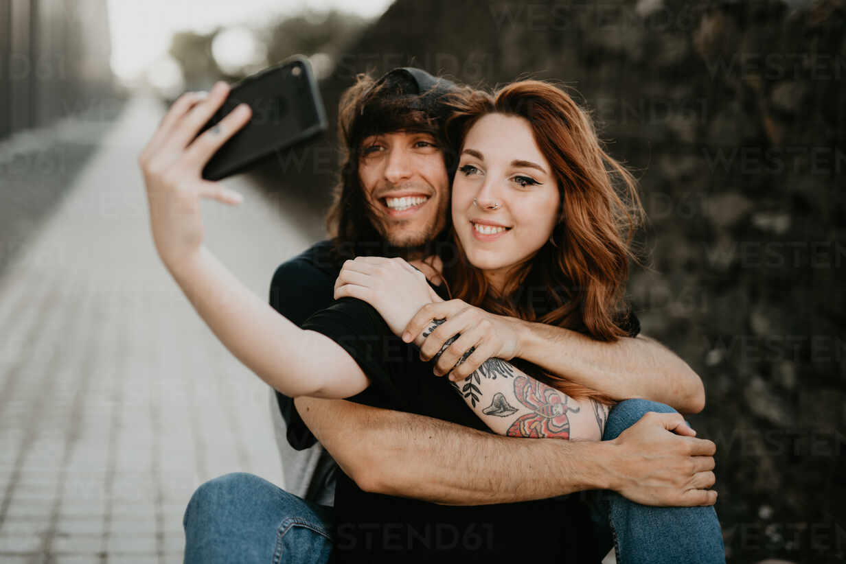 Premium Photo | Happy young beautiful loving couple posing walking outdoors  in park nature take selfie by mobile phone.