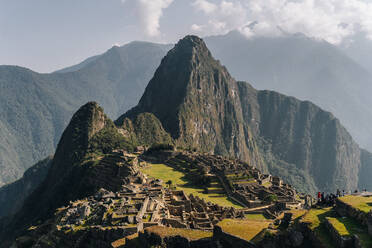 Machu Picchu, Peru. Amazing touristic landscape of ancient old labyrinth at stone peak in mountain under cloudy sky - ADSF07813