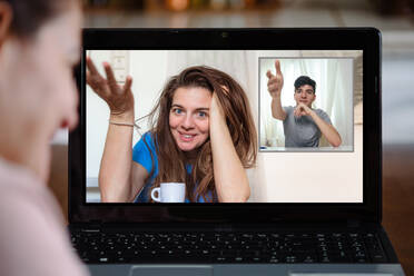 Woman having video conversation on laptop at home - ADSF07829