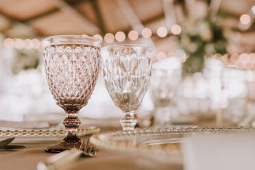 Beautiful empty wineglasses on banquet table on blurred background in modern restaurant - ADSF08057