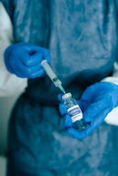 Nurse filling syringe with vaccine liquid - ADSF08090