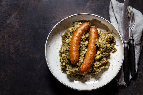 Plate of smoked sausages with kale - SBDF04302