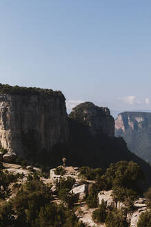 Distant view of man standing on mountain against sky at Vilanova de Sau,  Catalonia, Spain - MOSF00124