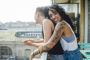 Happy women enjoying in balcony - MEUF01730