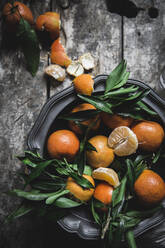 Mandarins and basket on table - ADSF08662