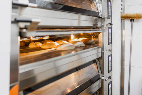 Bread baking bread in oven at commercial kitchen - MRRF00168