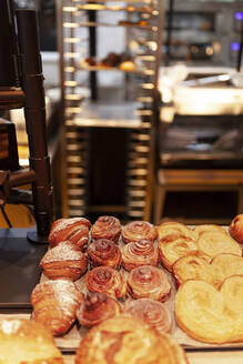 Close-up of prepared croissants and cinnamon rolls at bakery - MRRF00200