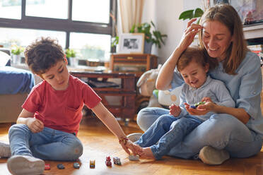 LOVING MOMENT OF HAPPY MOTHER PLAYING WITH HER CHILDREN - CAVF87797