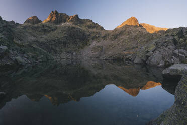 Granite peaks reflections over the lake at Sierra de Gredos, Spain - CAVF87807