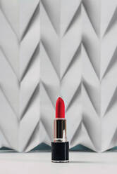 Pink lipstick on raised white chevron. Product and make up contemporary concept - ADSF08814