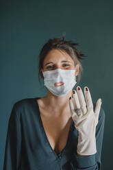 Young Woman Showing Mask And Glove With Make Up - ALBF01309
