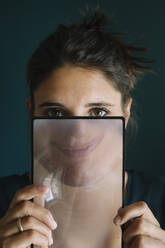 Young Woman Smiling Behind a Magnifying Glass - ALBF01341