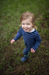 Happy girl with wet hair during rain looking at camera - BRF01488