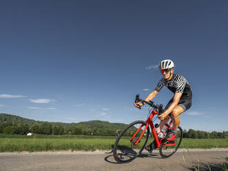 Man riding his racing bike - STSF02579