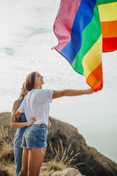 Two young women having fun with an LGBT flag - MIMFF00130