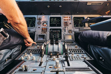 Pilot using flight management system during flight - ADSF09160