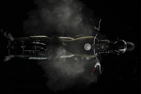 Top view of vintage motorcycle with smoke and black background (Ardie RZ 200 Peter) stock photo