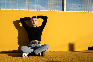 Calm young woman enjoying sunlight on stadium - ADSF09372