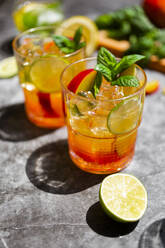 Cocktail with peach, mint and lime and ice cubes - GIOF08713