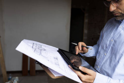 Architekt bei der Arbeit mit Tablet und Bauplan - VABF03313