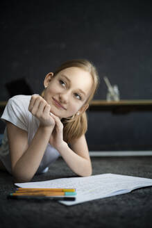 Girl lying on carpet and learning at home - DKOF00027