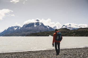 Mann hält Fernglas beim Wandern im Torres Del Paine Nationalpark, Chile, Patagonien, Südamerika - UUF20819