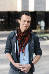 Confident fashionable man standing on street in city - JMPF00290