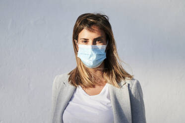 Businesswoman wearing protective face mask during COVID-19 - KIJF03203