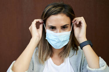 Businesswoman wearing protective face mask - KIJF03206