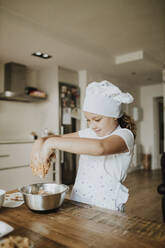 Girl making cookies at home - GMLF00427