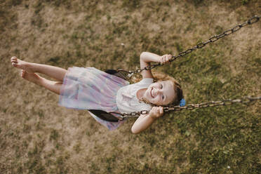 Happy little girl on a swing - SMSF00076