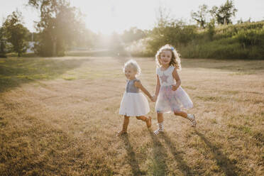 Happy girls on a meadow in backlight - SMSF00087