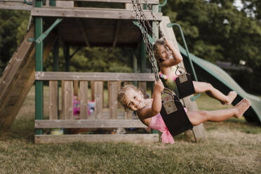 Happy girls with wet hair on a swing - SMSF00134