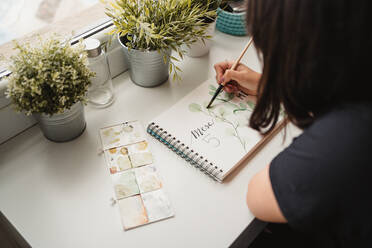Crop from above view of unrecognizable woman drawing picture with watercolors at home in Paris - ADSF10052