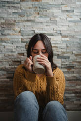 Woman drinking hot tea at home - ADSF10064