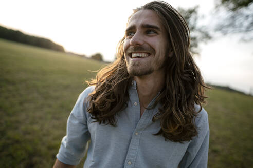 Happy young man on a meadow in the countryside - KNSF08318