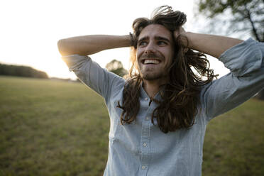 Happy young man on a meadow in the countryside - KNSF08319