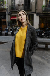 Young woman looking up in city - RDGF00019