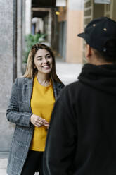 Young smiling woman during meeting with young man in city - RDGF00022